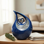 Load image into Gallery viewer, SOULURNS Teardrop Cremation Urn with Heart Cutout – Decorative Memorial Urn for Ashes, Blue Enamel with Silver Embossed Detail, Solid Aluminum, Felt-Lined Base, 2 Litres